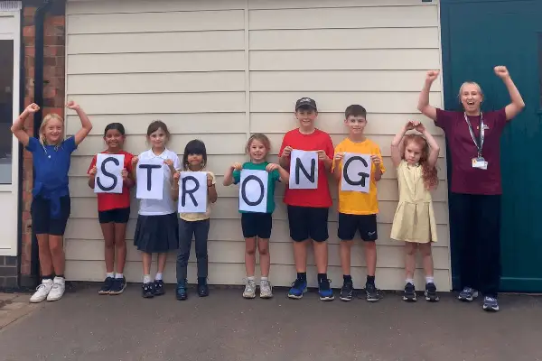 Children from Markeaton Primary School Holding up the letters S T R O N G