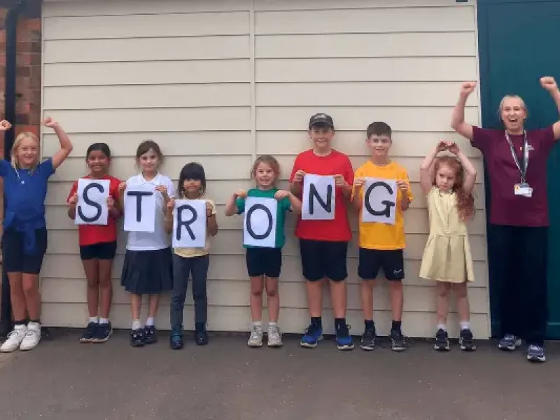 Children from Markeaton Primary School Holding up the letters S T R O N G